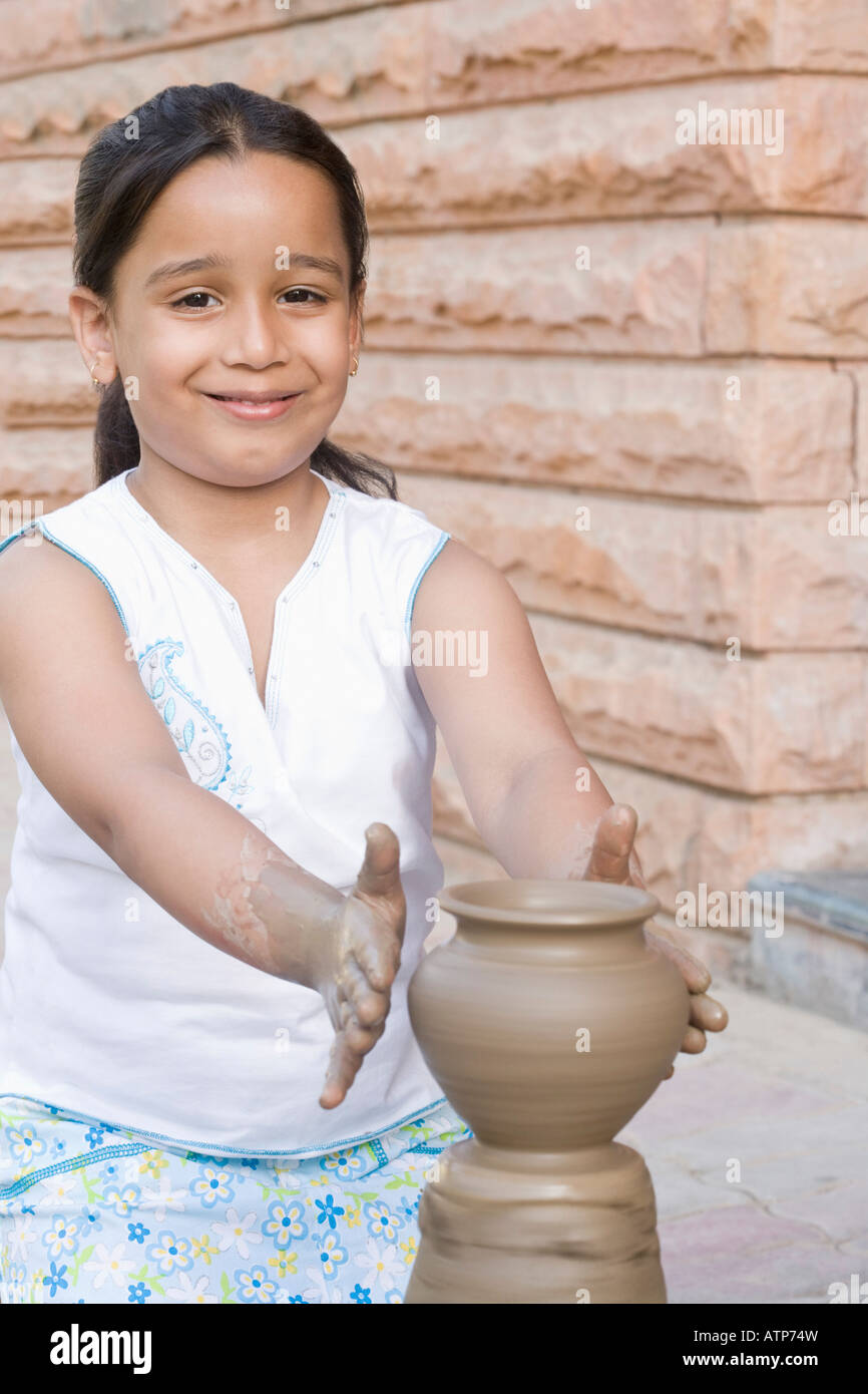 Portrait of a girl making a pottery and smiling Stock Photo Alamy