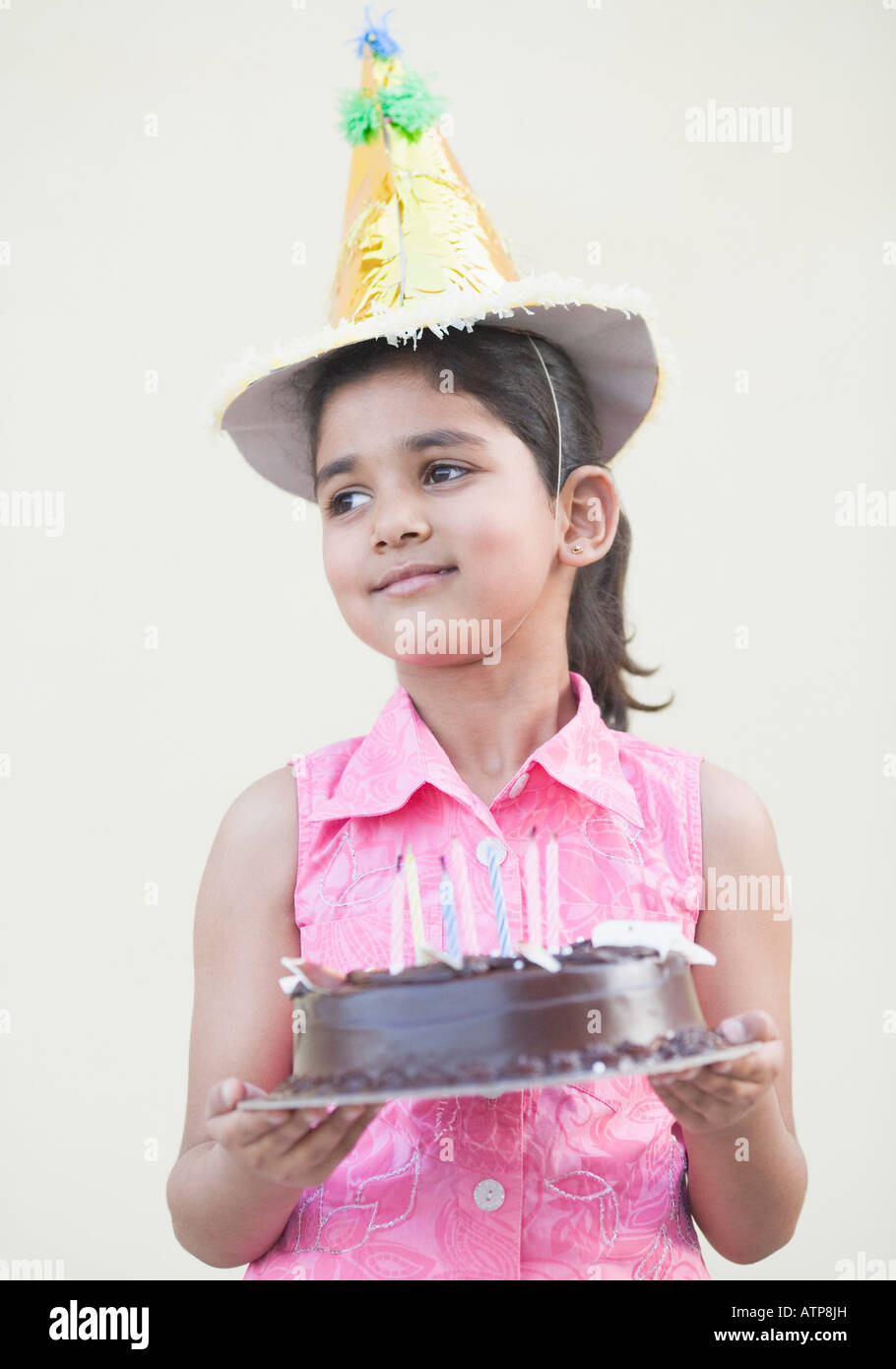 Girl holding a cake and smiling Stock Photo - Alamy