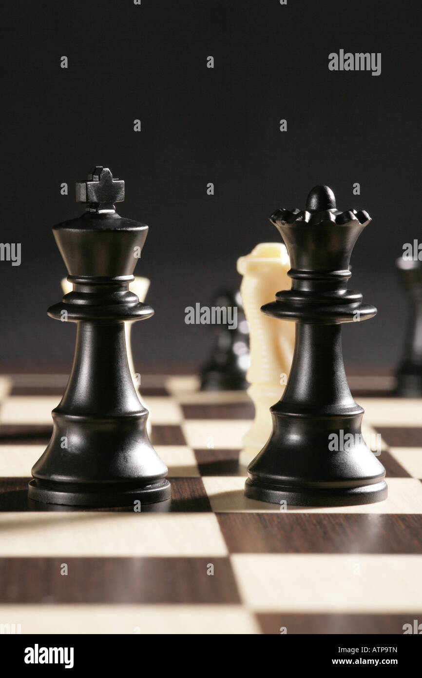 Chess pieces with black King and Queen dominant Stock Photo