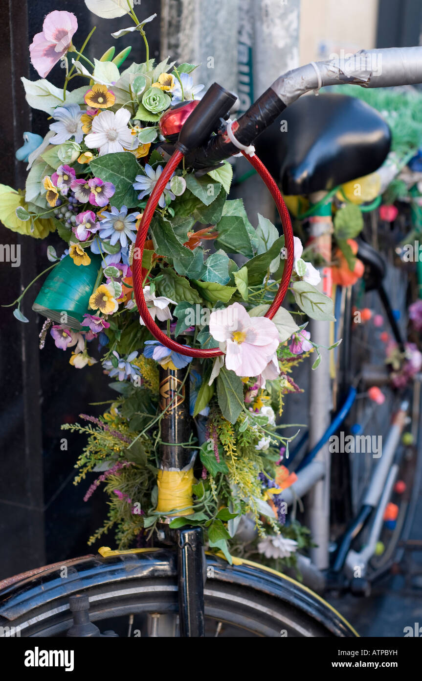 A bicycle in Amsterdam decorated with flowers. Stock Photo