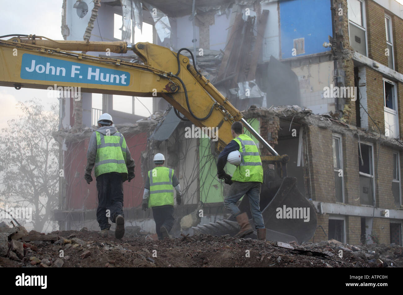 Construction workers working on the demolition of a housing estate. Stock Photo