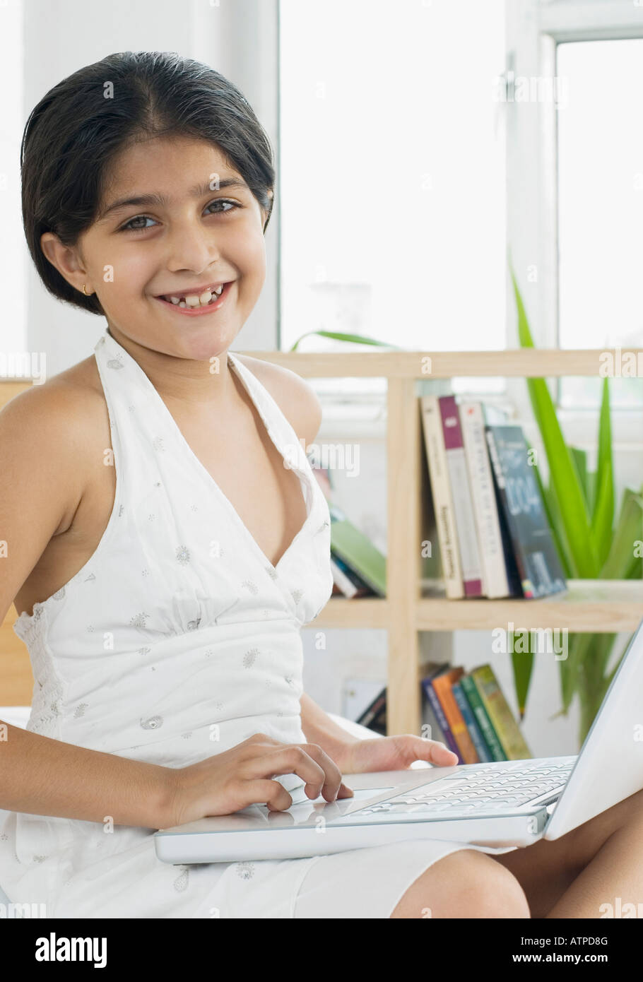 Portrait of a girl using a laptop and smiling Stock Photo - Alamy