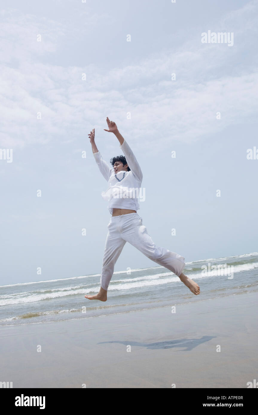 Young man exercising on the beach Stock Photo