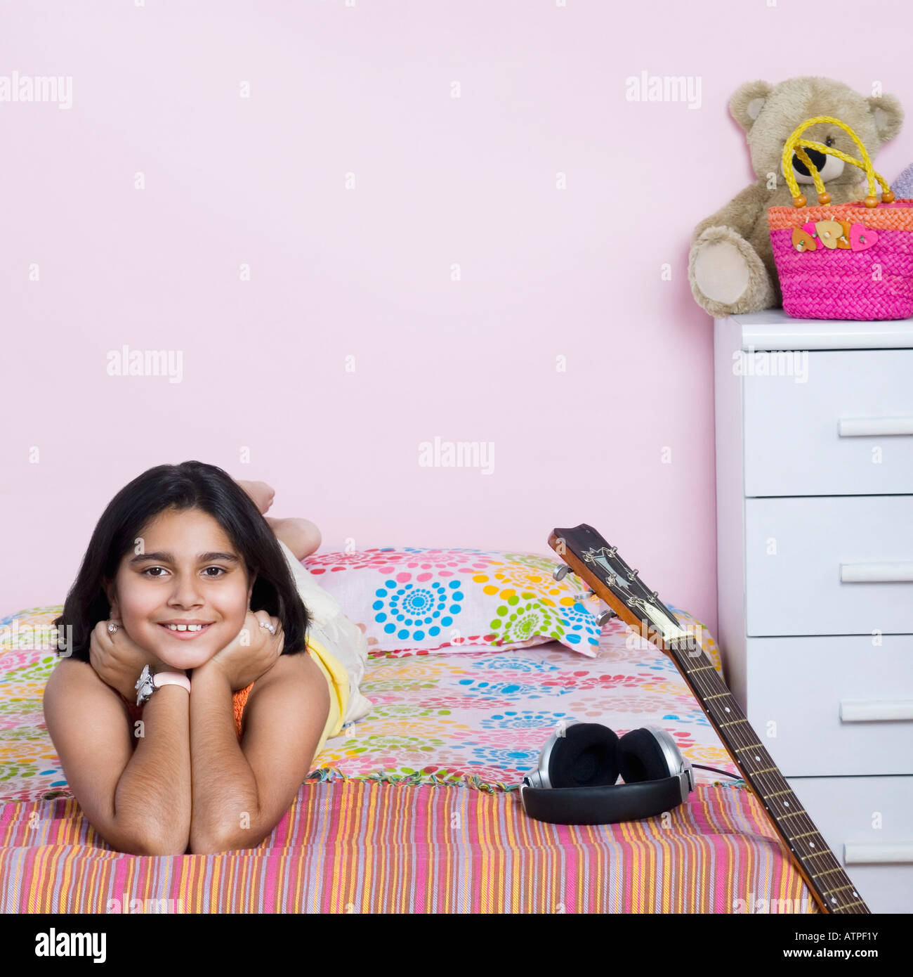 Portrait of a girl lying on the bed and smiling Stock Photo - Alamy