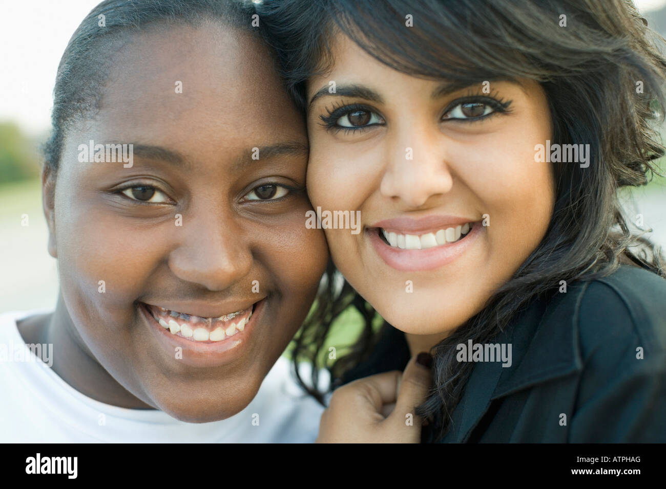 Portrait of two young women smiling Stock Photo - Alamy
