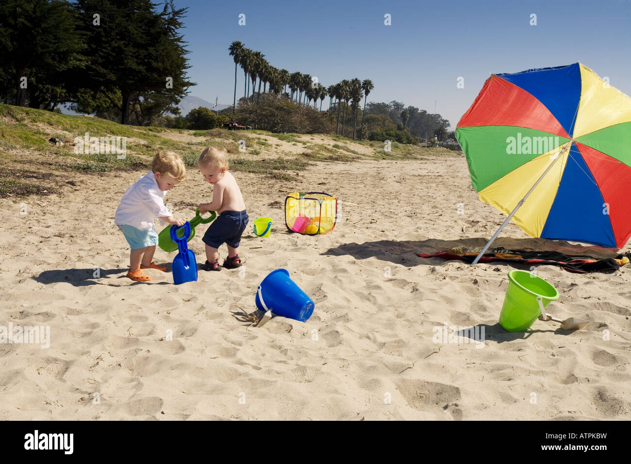 Two boys play in the sand at the beach Stock Photo - Alamy