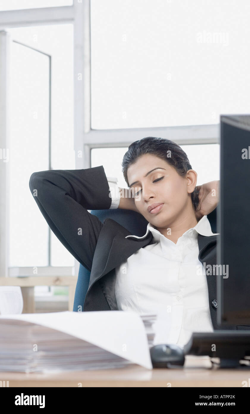 Businesswoman sleeping in office chair hires stock photography and