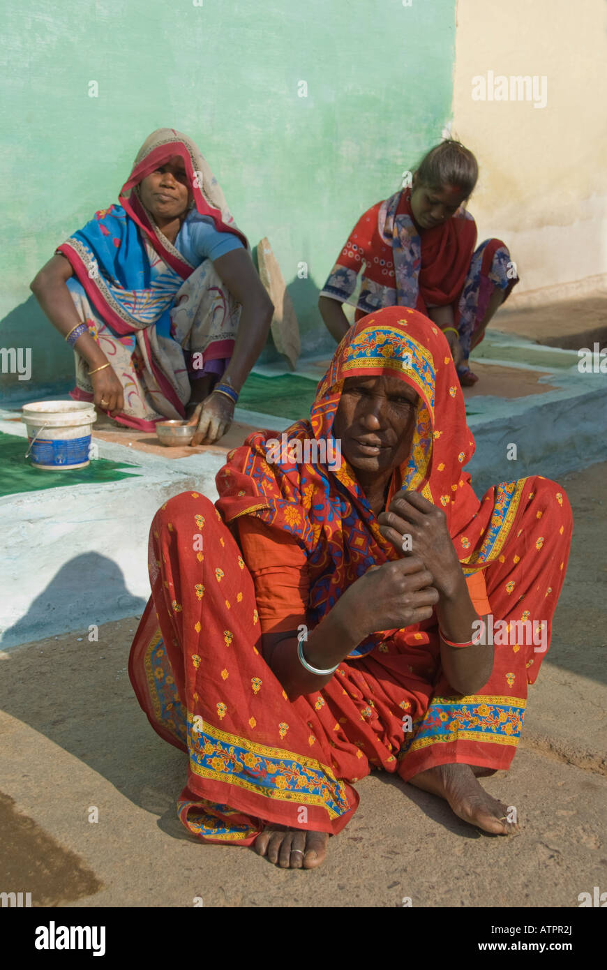 Three Indian women working on repairing a pavement. Stock Photo