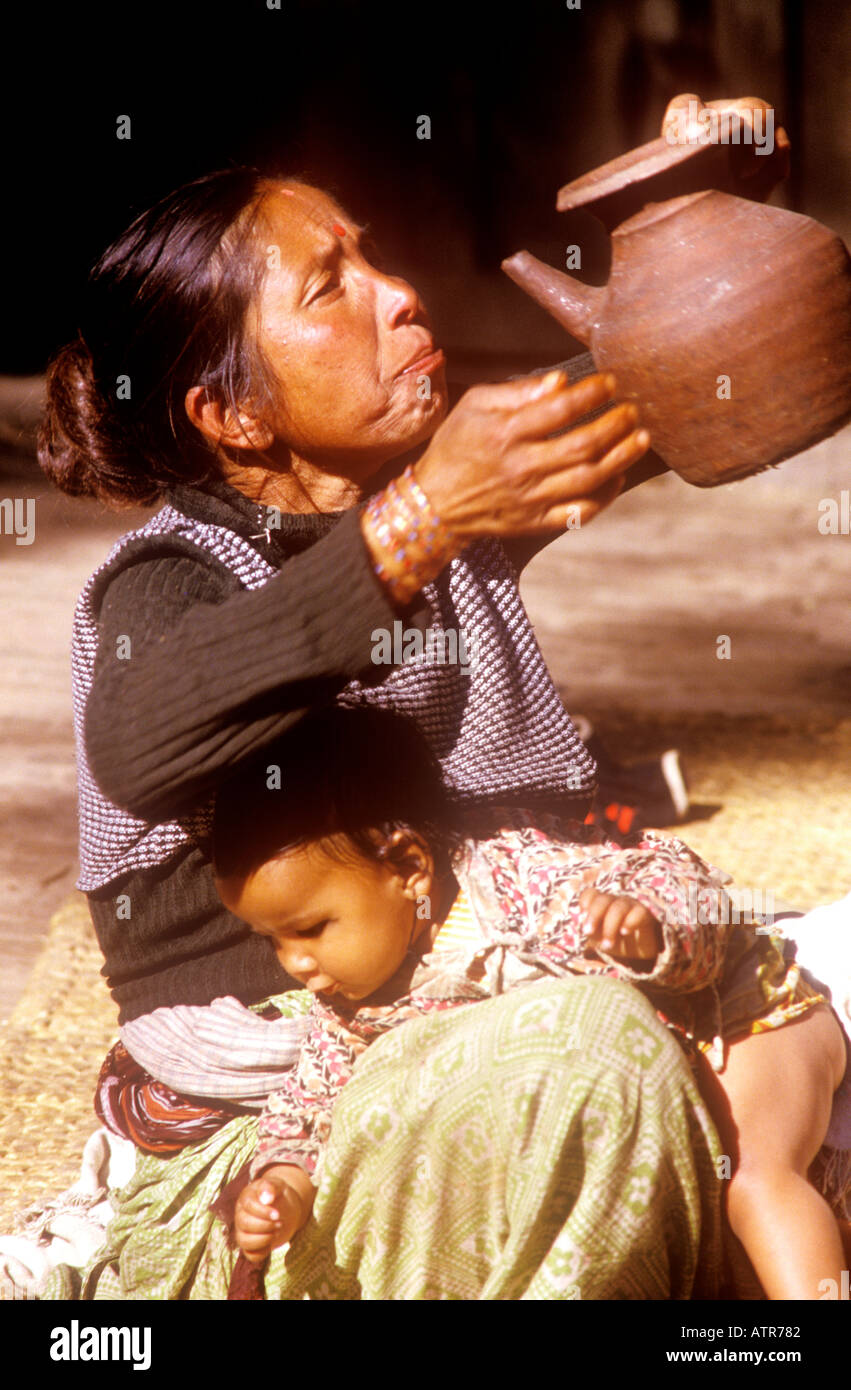 Elderly woman drinking water with child Suryavinayak Nepal Stock Photo
