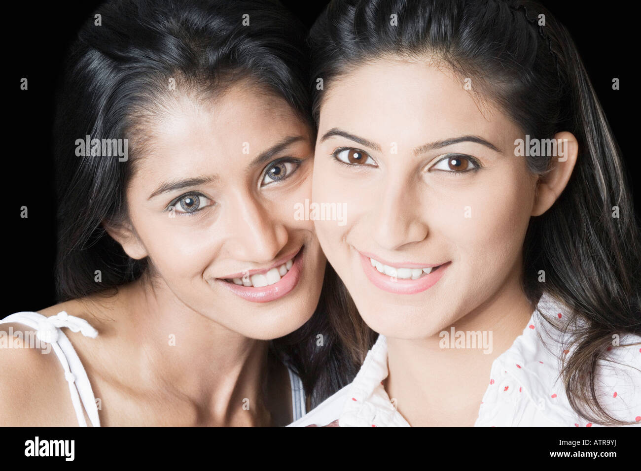 Portrait of two young women smiling Stock Photo - Alamy