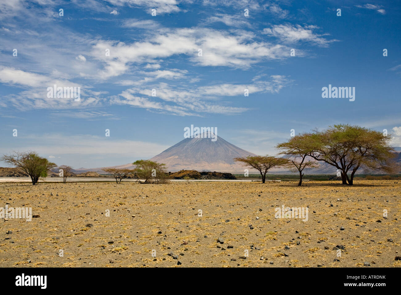 Ol' Doinyo Lengai volcano (Mountain of God) in a distance viewed from Lake Natron, Tanzania, Africa Stock Photo