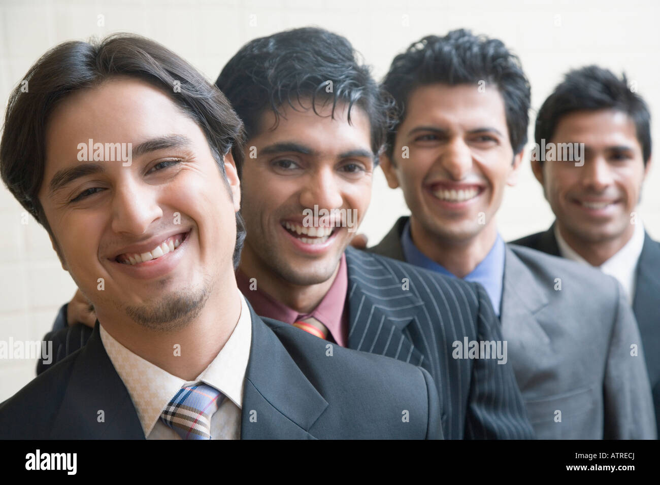 Portrait of four business executives smiling Stock Photo - Alamy