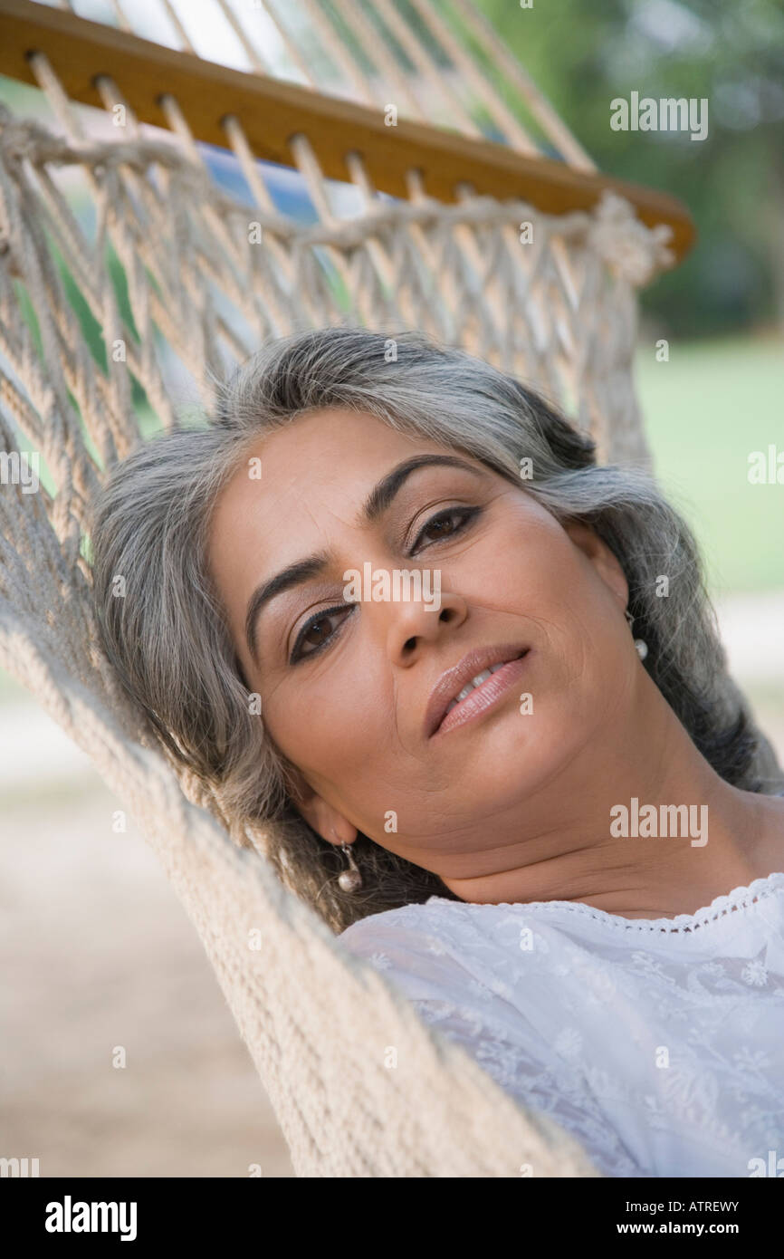 Portrait of a mature woman lying in a hammock Stock Photo - Alamy