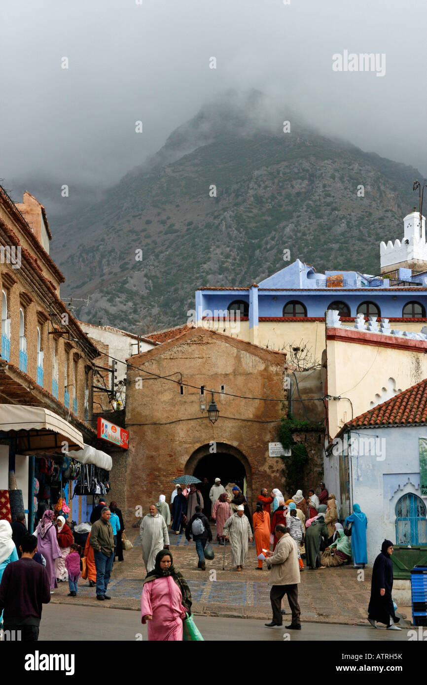Bab el Ain the main gateway to the Medina in Chefchaouen sits beneath a cloud swathed mountain Stock Photo