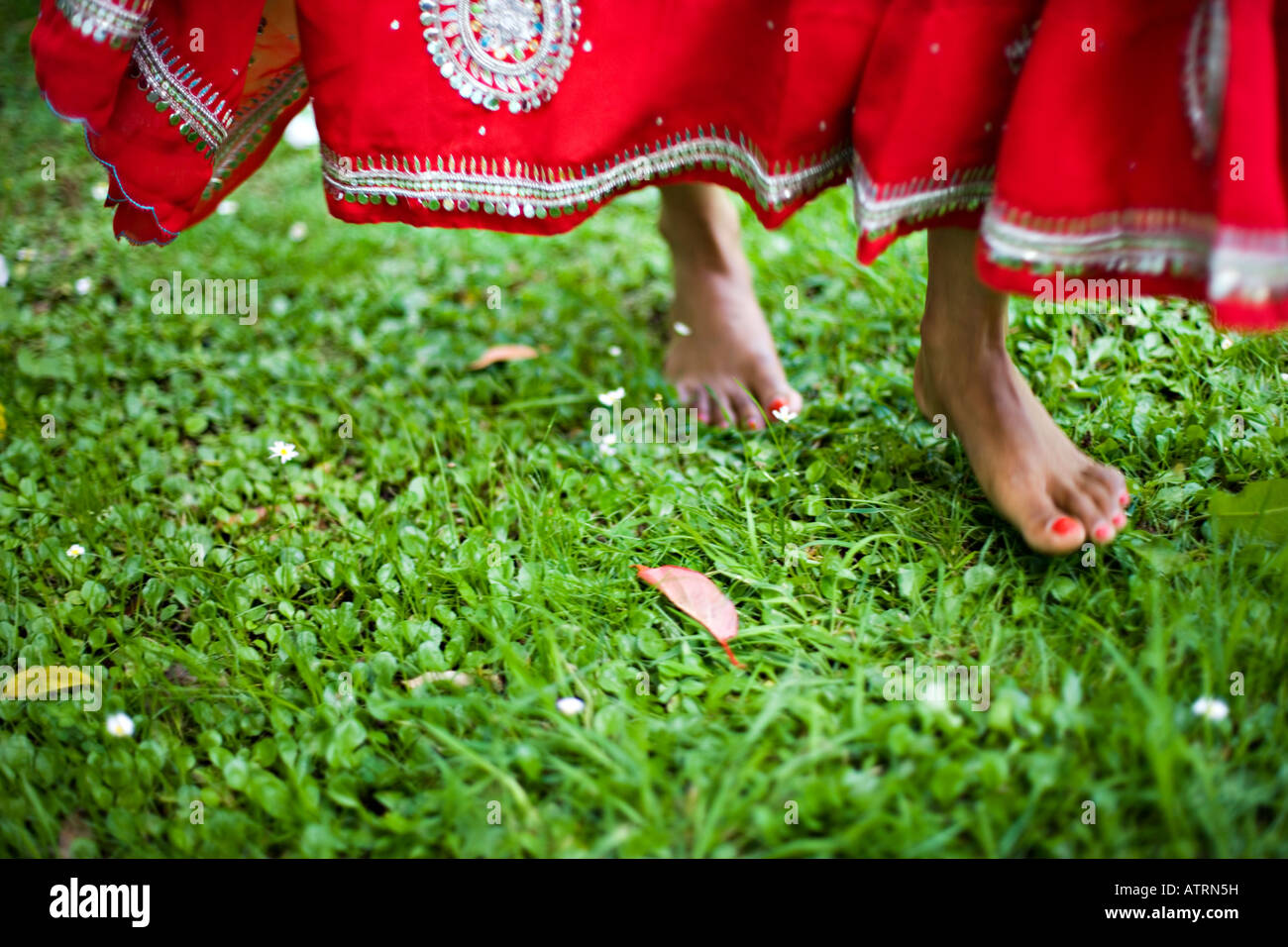 Dancing feet in red sari Stock Photo