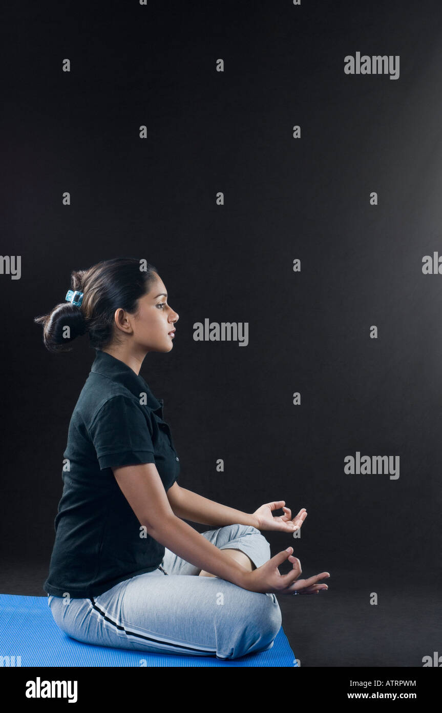 Side profile of a young woman meditating Stock Photo