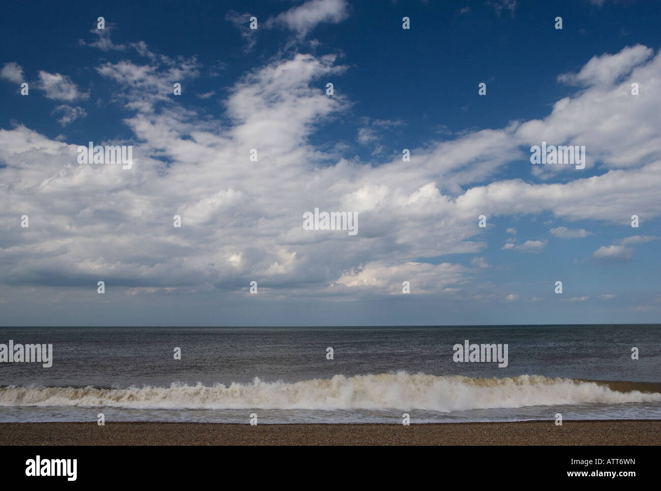 White Clouds in a blue sky over the Salthouse Beach Stock Photo
