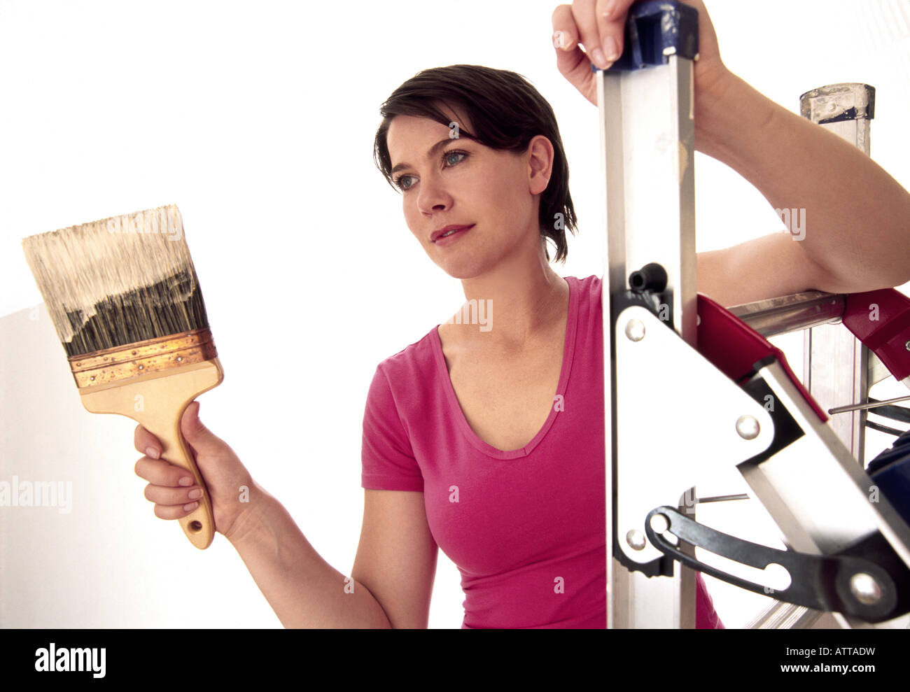Young woman painting wall Stock Photo