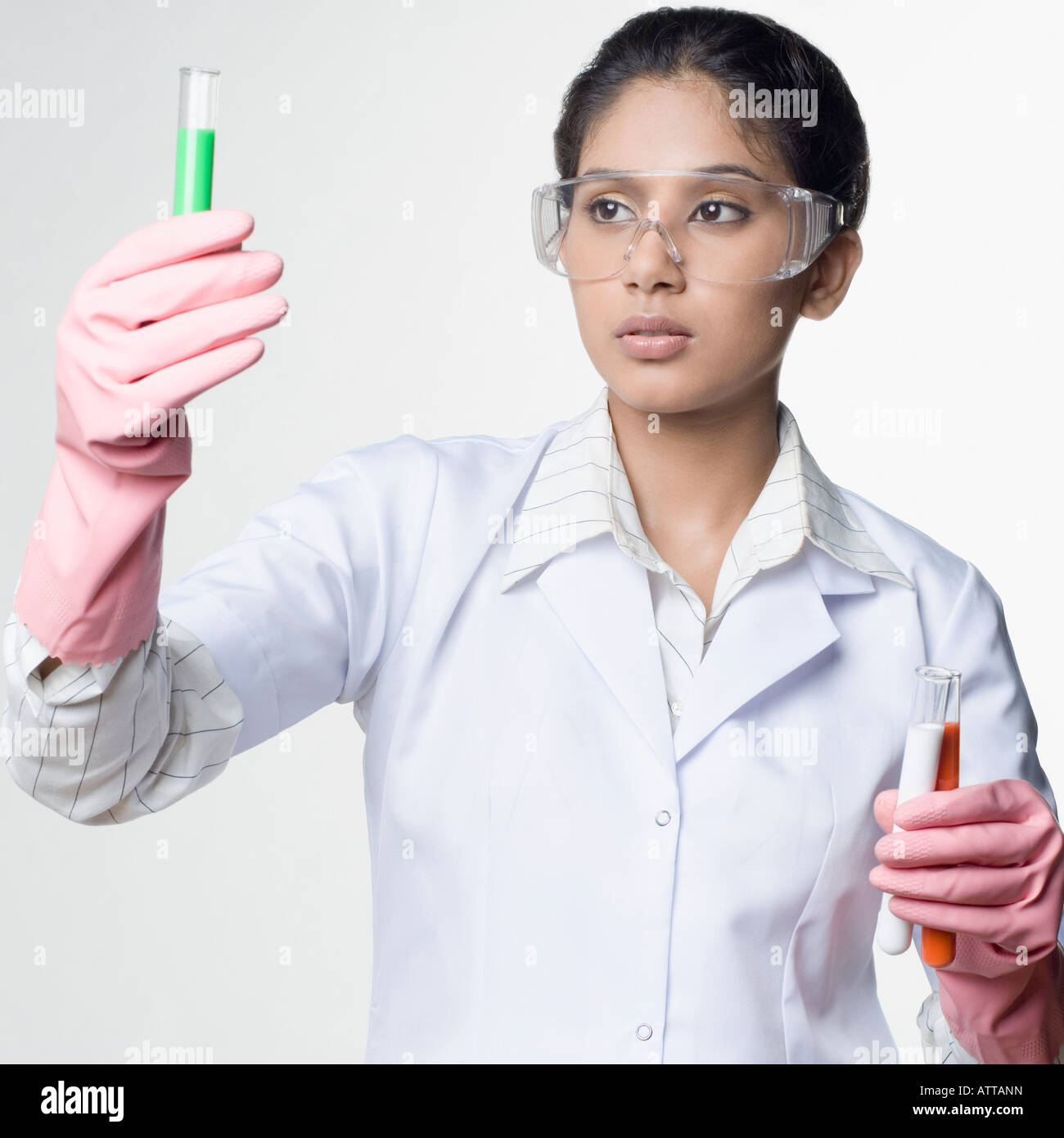 Closeup of a female lab technician looking at a test tube Stock Photo