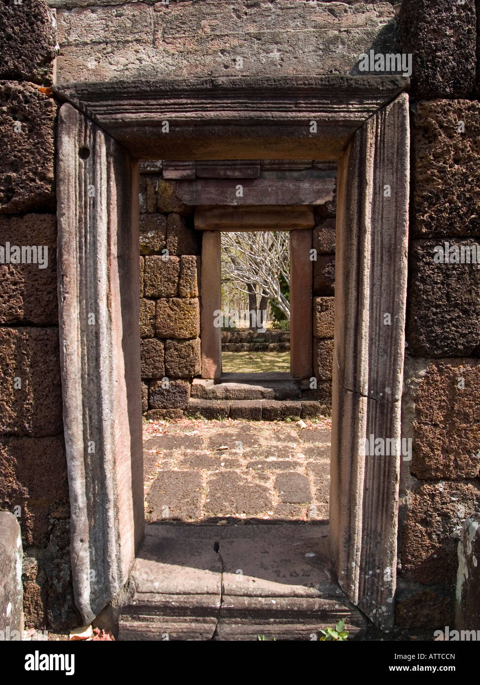 view through ancient windowframe at Phanom Rung Khmer ruins in Thailand Stock Photo