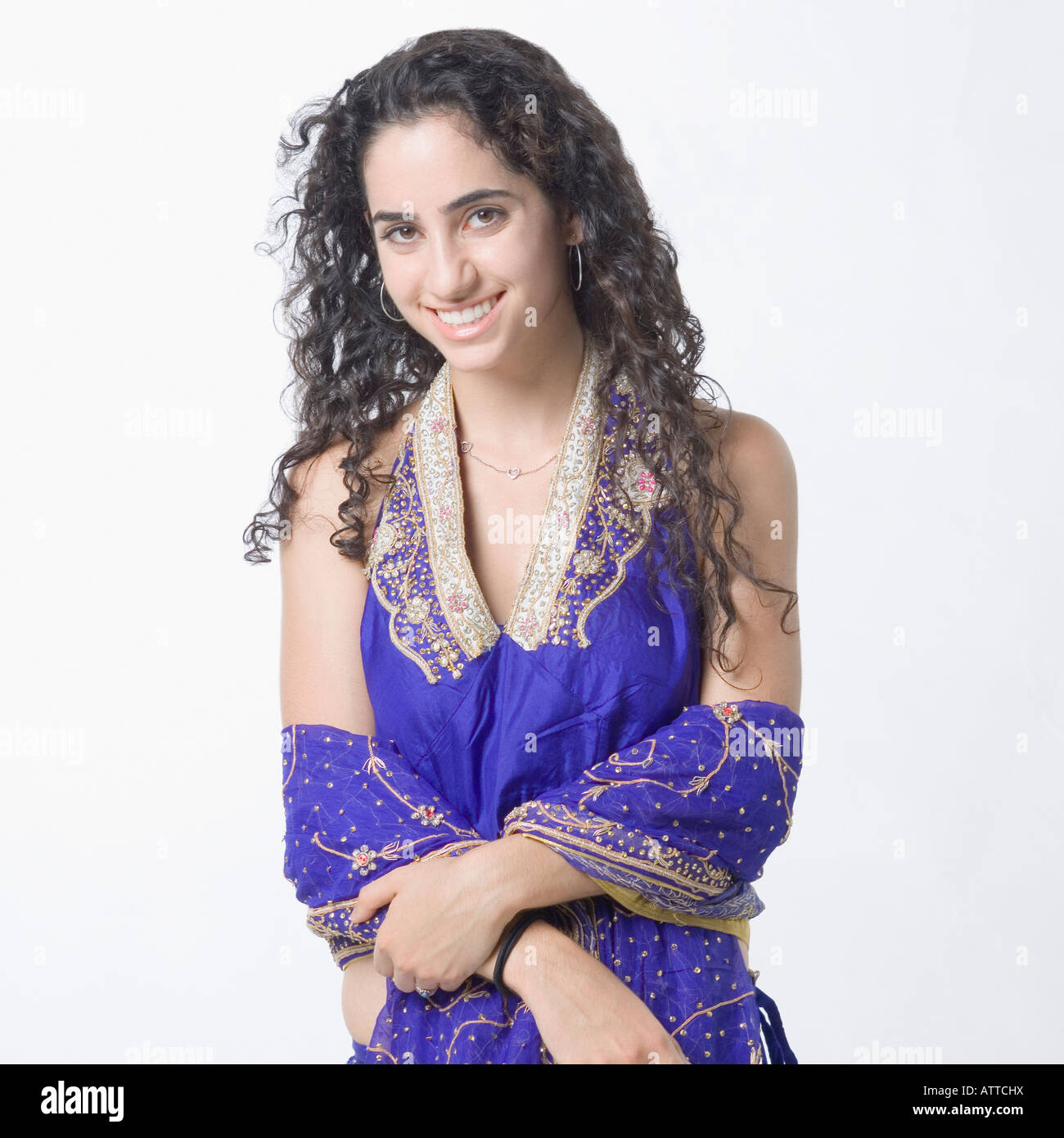 Portrait of a young woman posing in traditional clothing and smiling ...