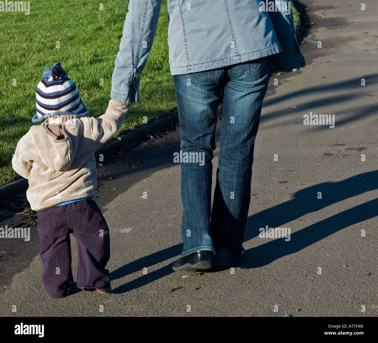 Proud mother helping child to walk hi-res stock photography and images ...