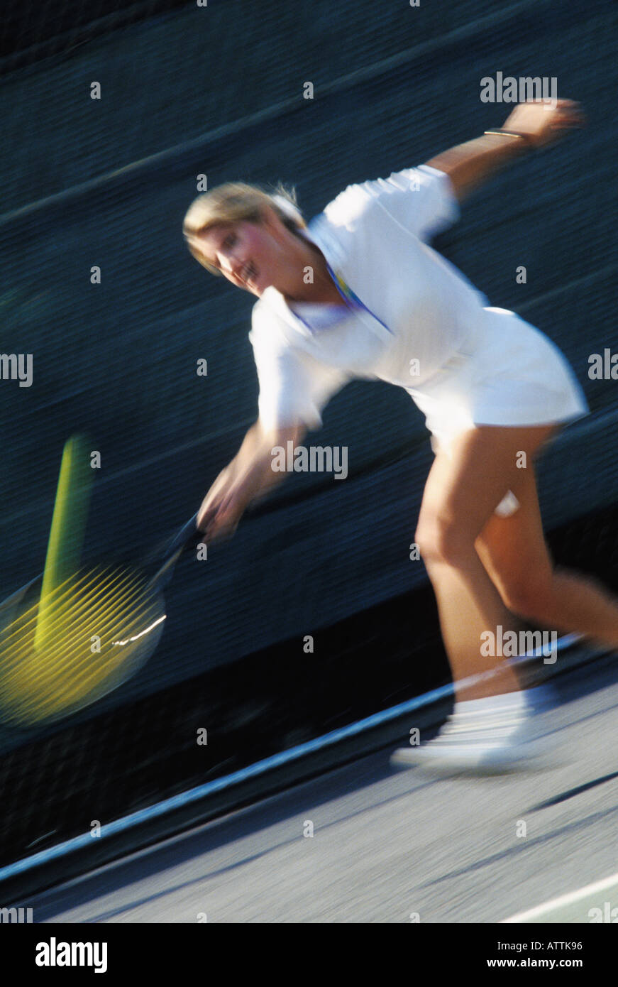 Young woman hitting a tennis ball Stock Photo
