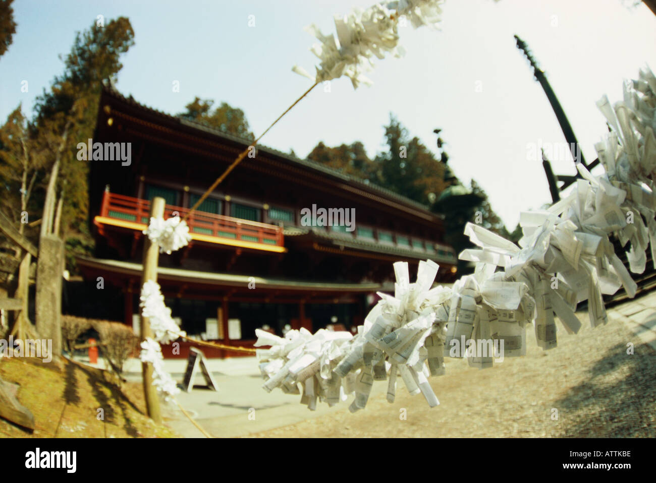 Omikuji prayers in foreground of temple in Japan Stock Photo