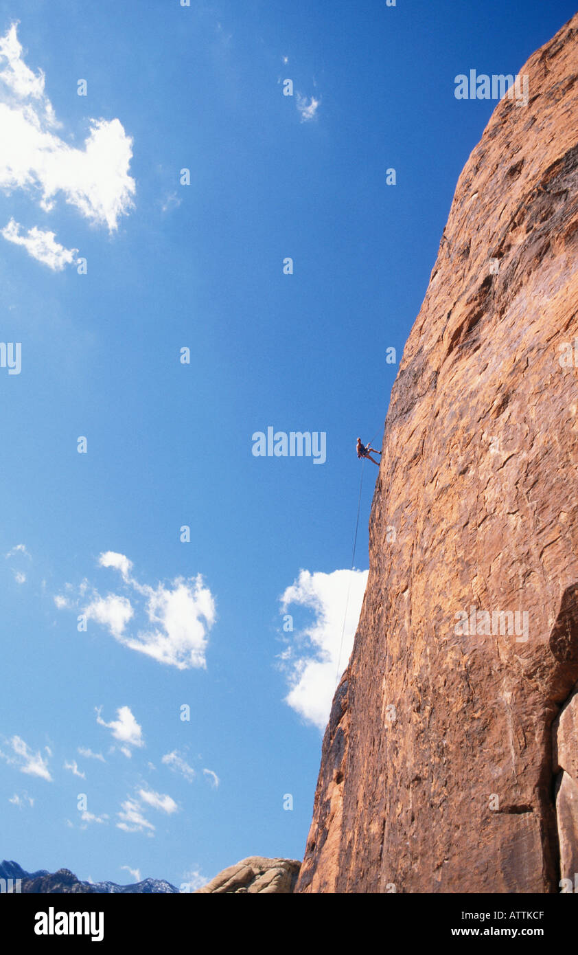 Rock climber rappelling off cliff at Red Rocks National Monument Nevada USA Stock Photo