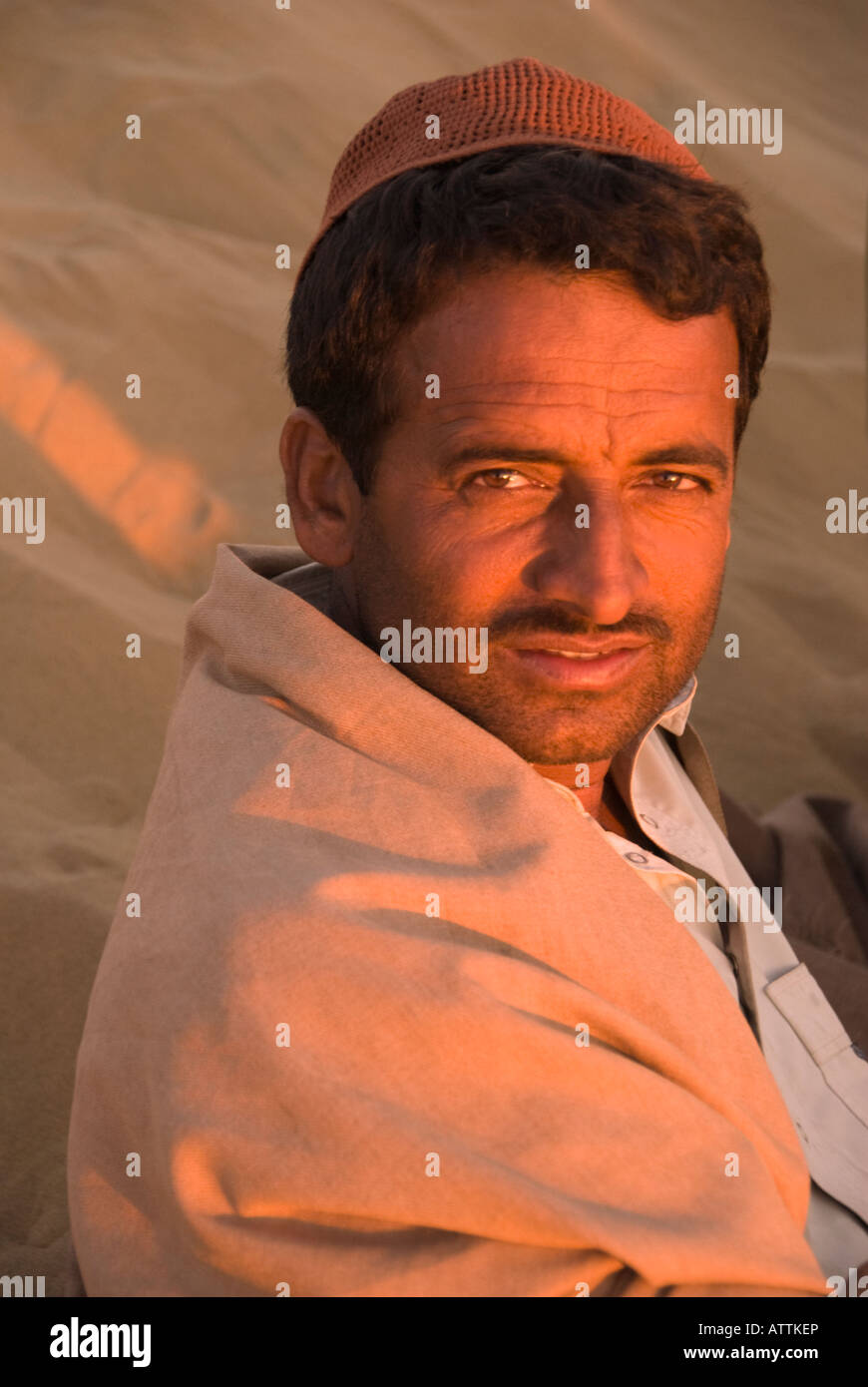 Portrait of a Handsome Camel Driver in the Dunes Stock Photo