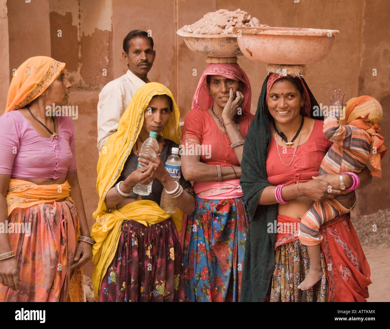Group portrait of four women, a man and a baby at a worksite in Jaipur, Rajasthan, India Stock Photo