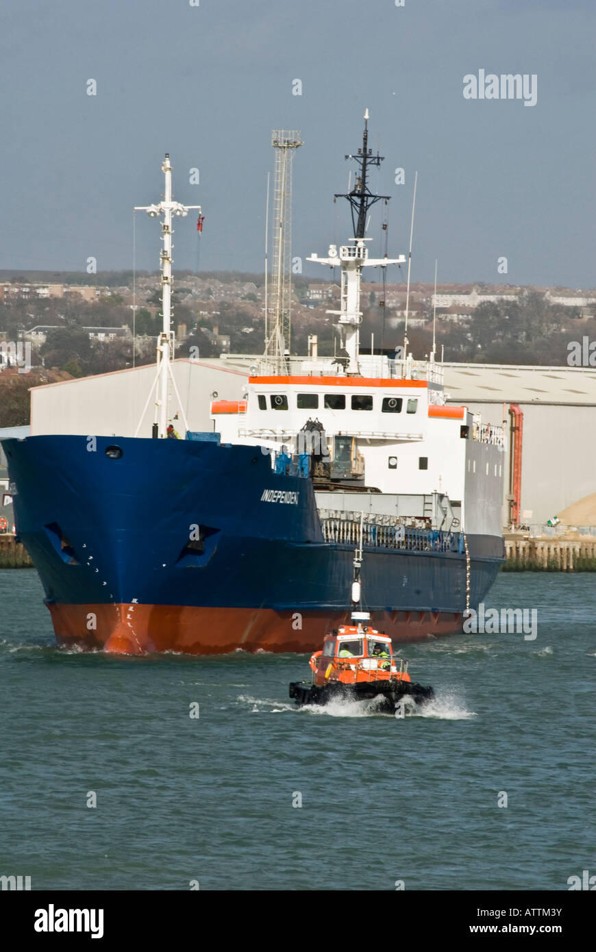 Container Ship escorted docks pilot launch Stock Photo