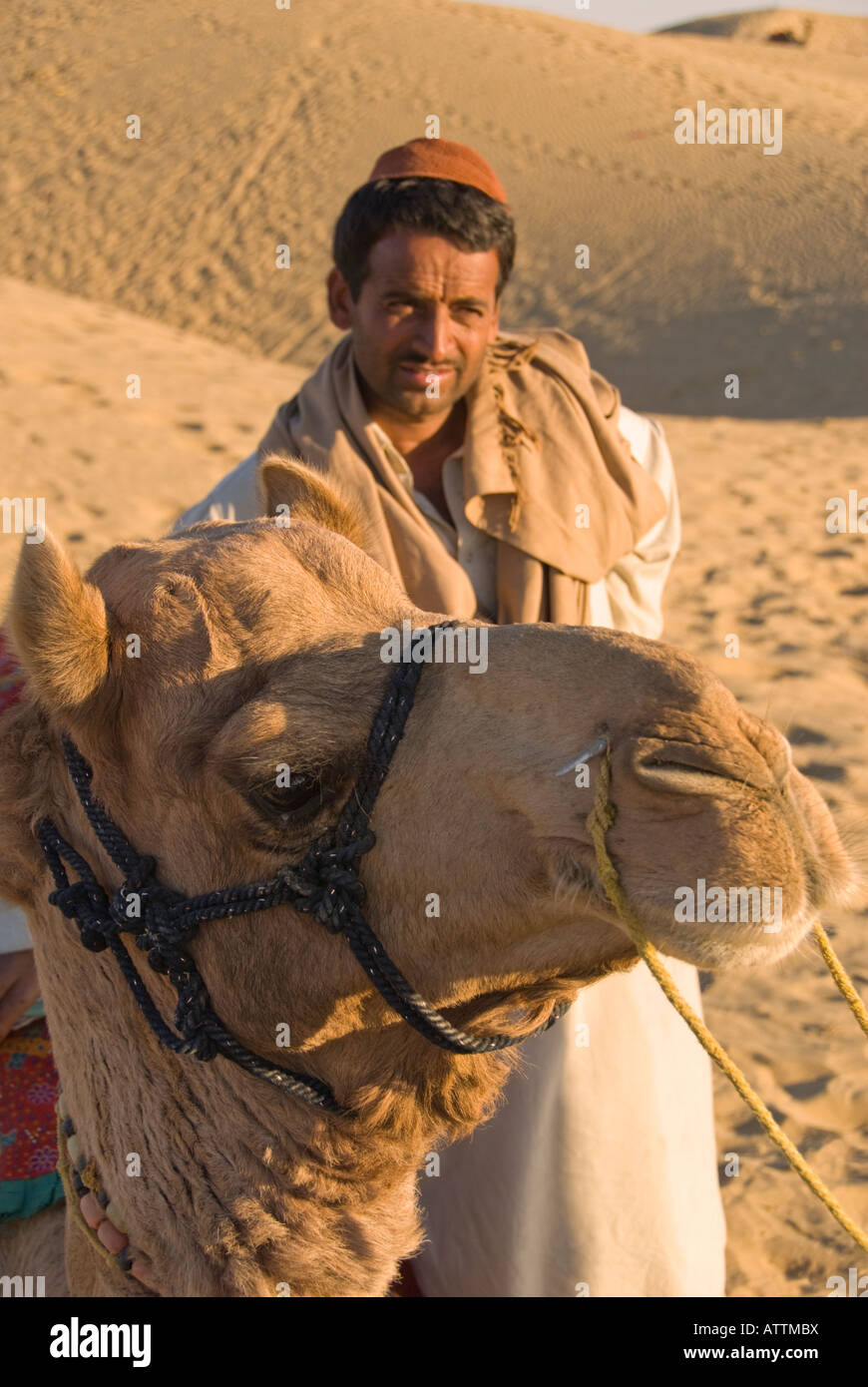 Portrait of a handsome male camel driver with his camel in the Thar Desert bordering India and Pakistan Stock Photo