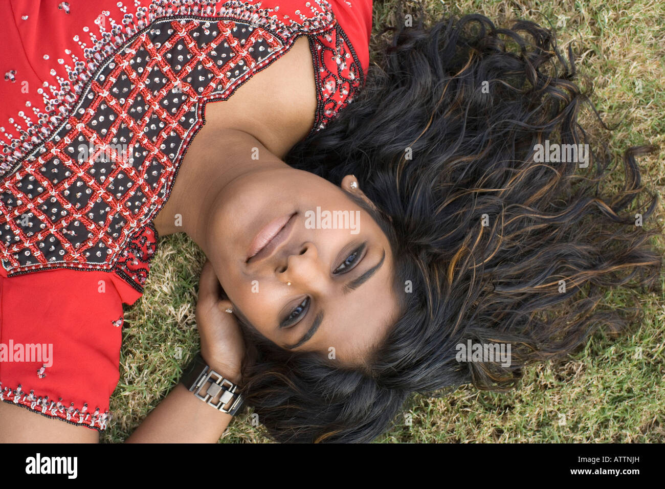 Portrait of a young woman lying on the grass Stock Photo - Alamy