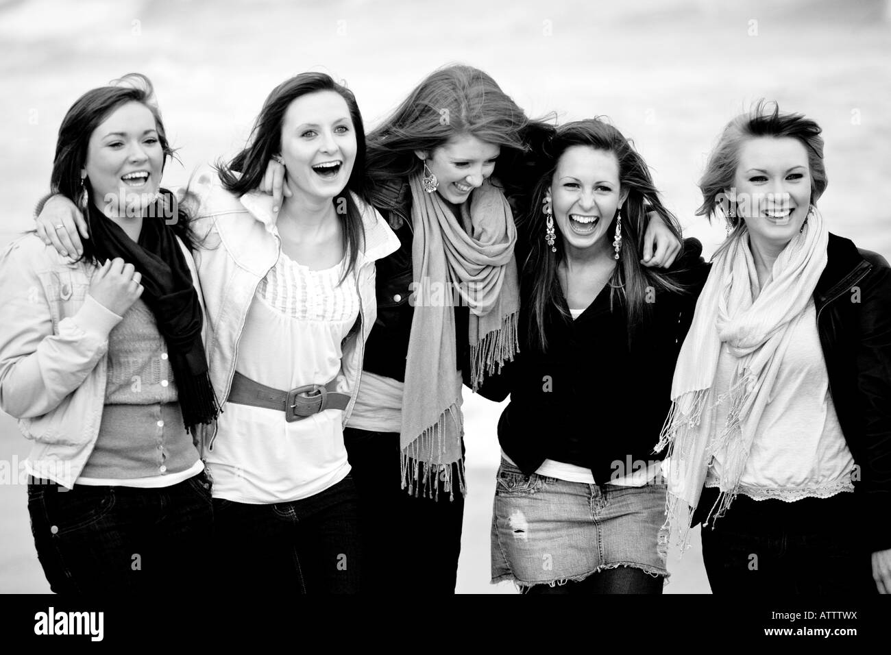 Black Women Laughing A teenage group of girl friends on a beach in black and 