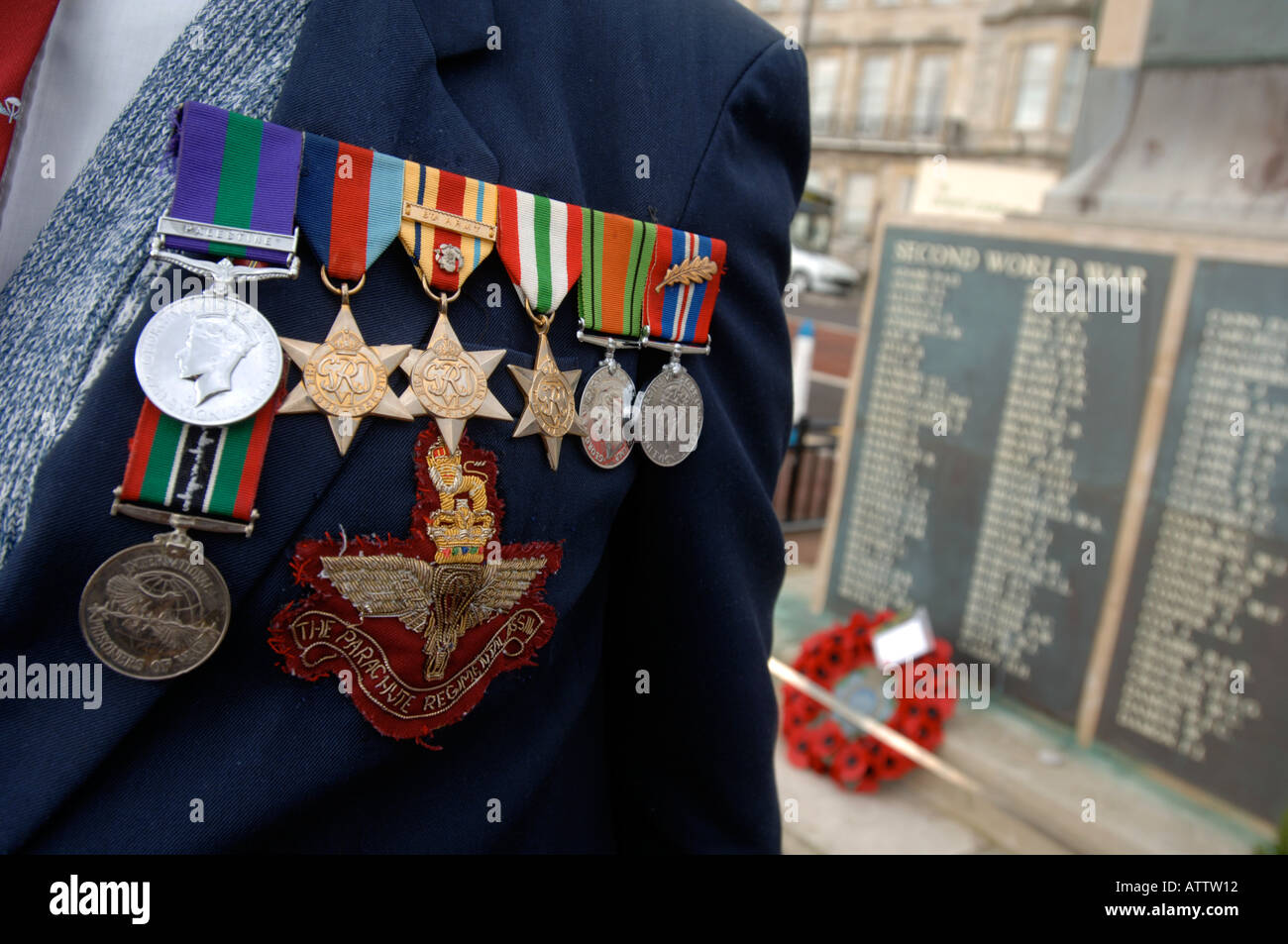 Veterans medals on his chest in front of World War cenotaph Stock Photo