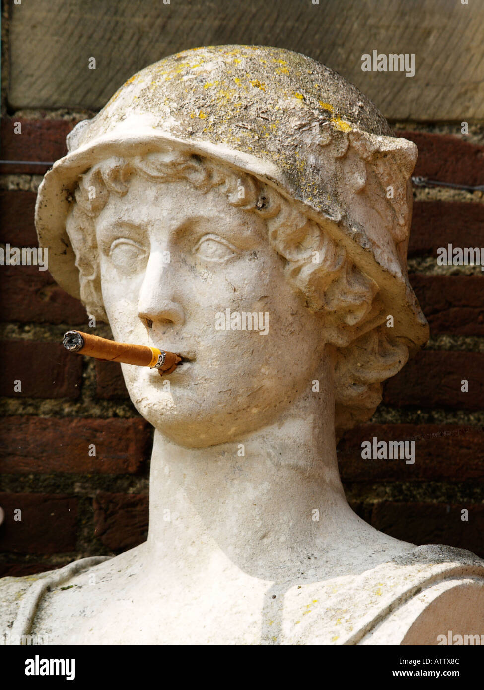A limestone statue of a Roman soldier with a cigar in his mouth Stock Photo