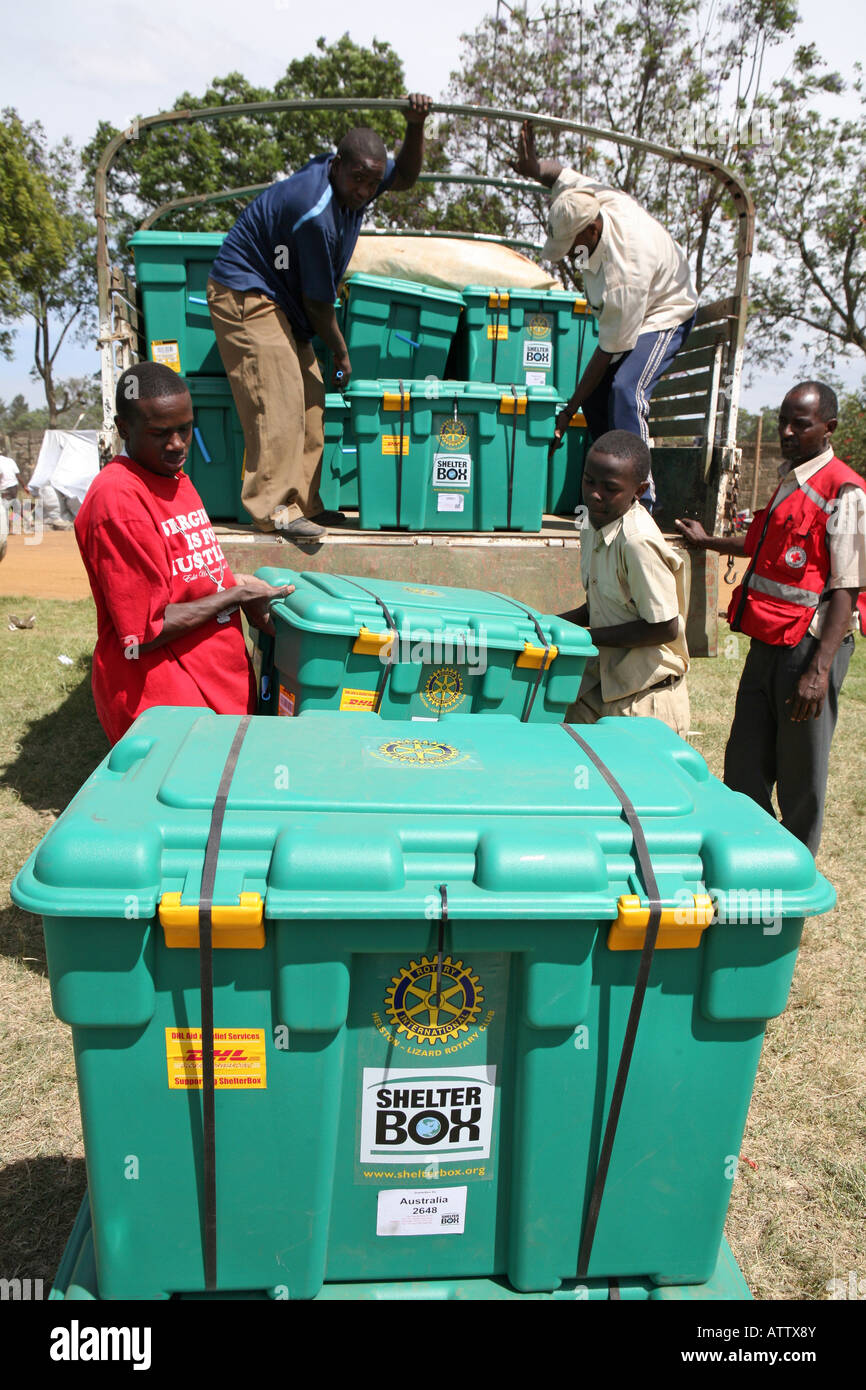 Red Cross volunteers unload Shelterboxes in Nakuru's Afhara Stadium, Nakuru, Kenya Africa Stock Photo