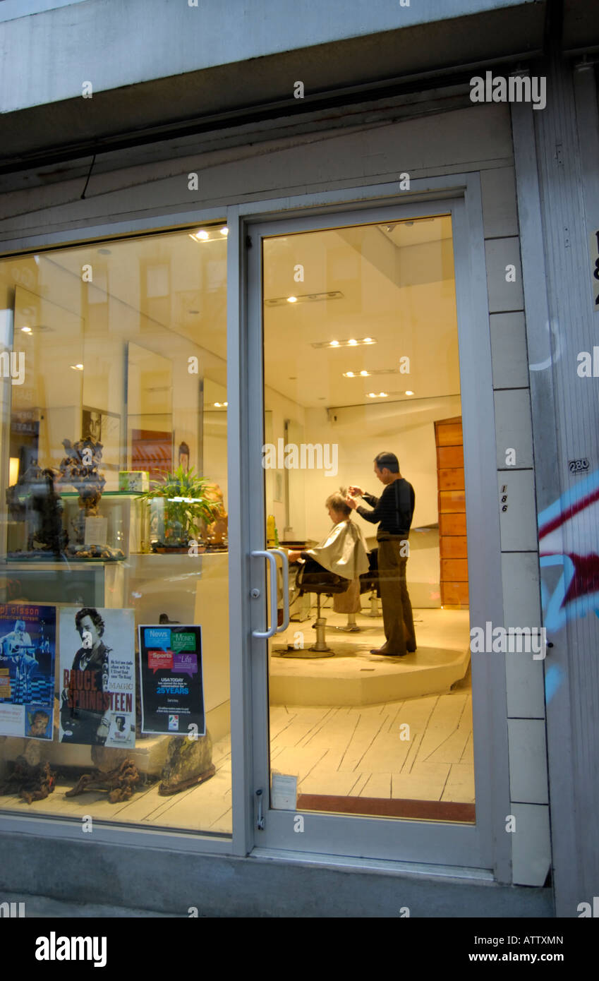 An Asian Hairdresser Cutting A Woman S Hair In Soho In New York