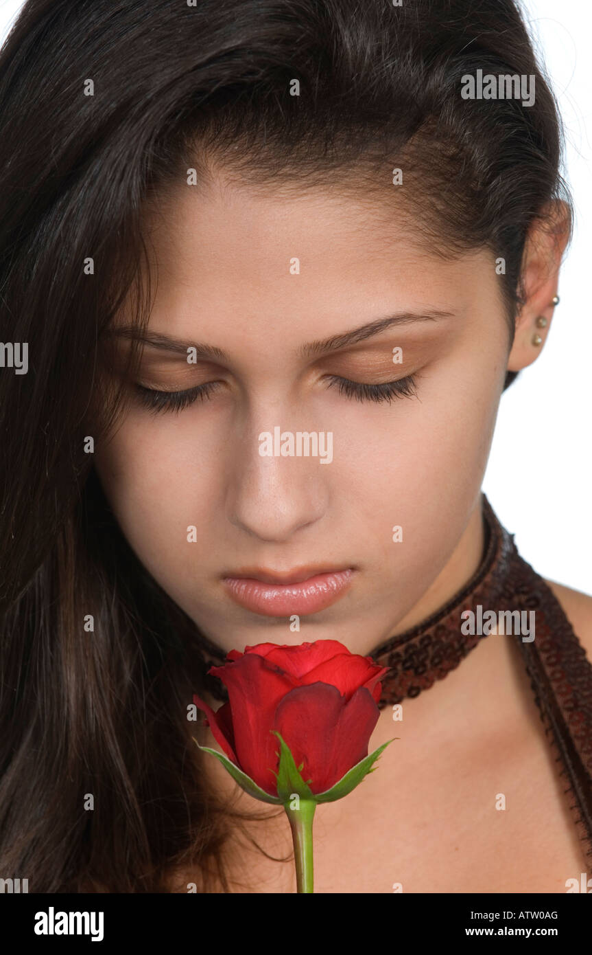 Close up of a beautiful teenage girl smelling red rose Stock Photo - Alamy