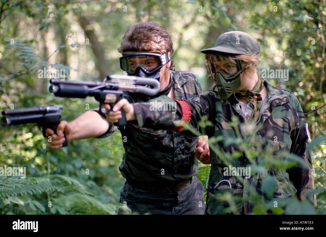 Playing the war game paint ball Stock Photo Alamy