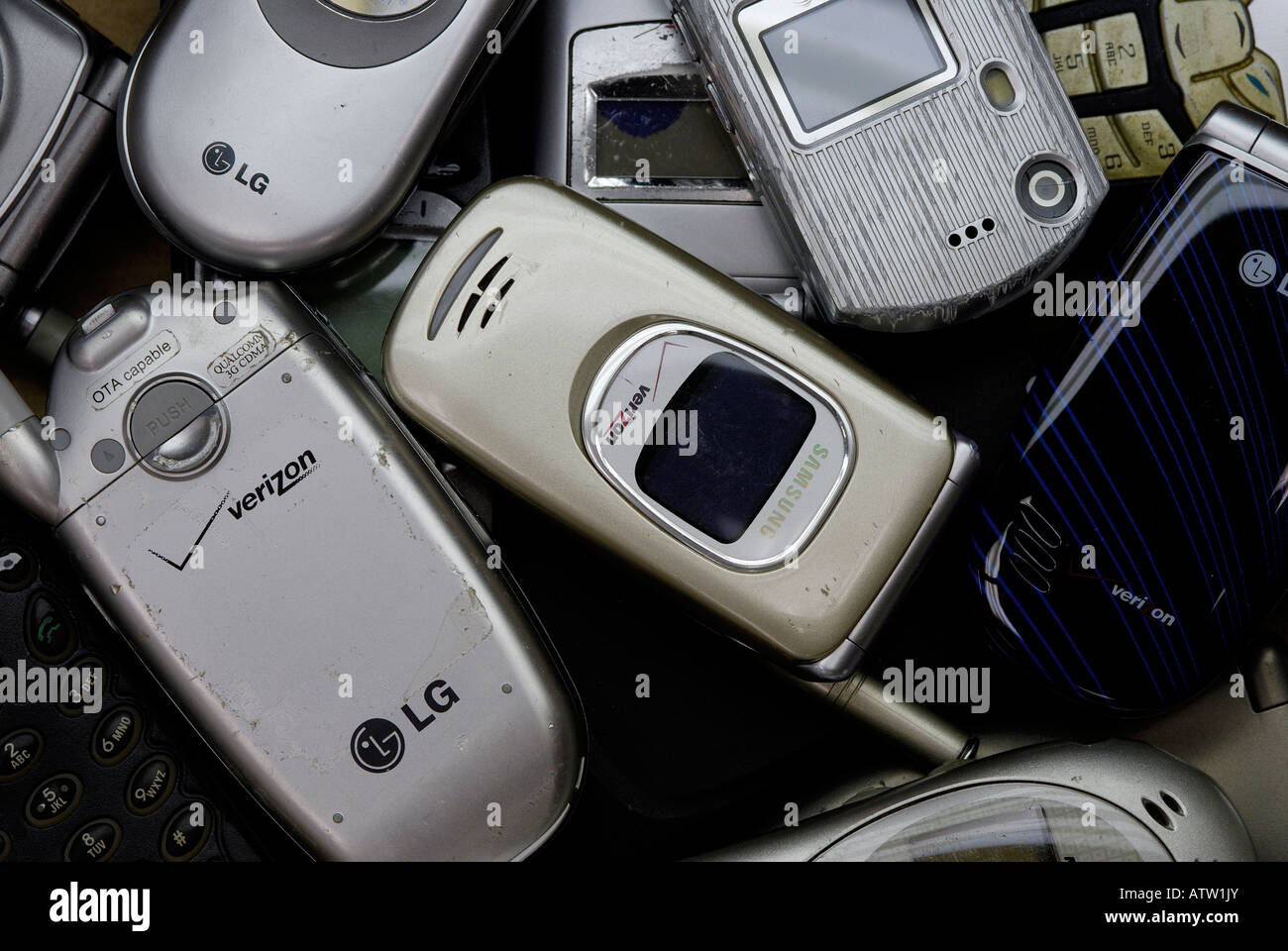 Old flip cell phones collected to be shipped to a recycling center Stock Photo