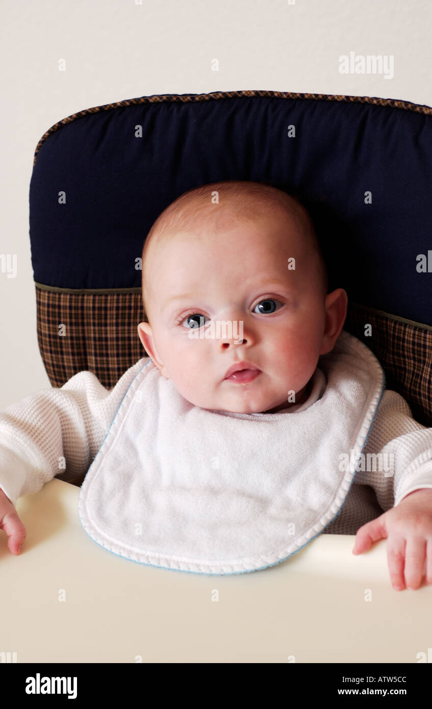 Baby in highchair waiting for food Stock Photo