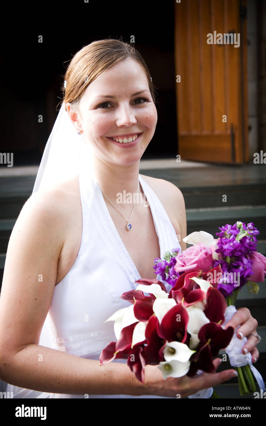 A smiling bride holding her beautiful bouquet The focus is on her face ...