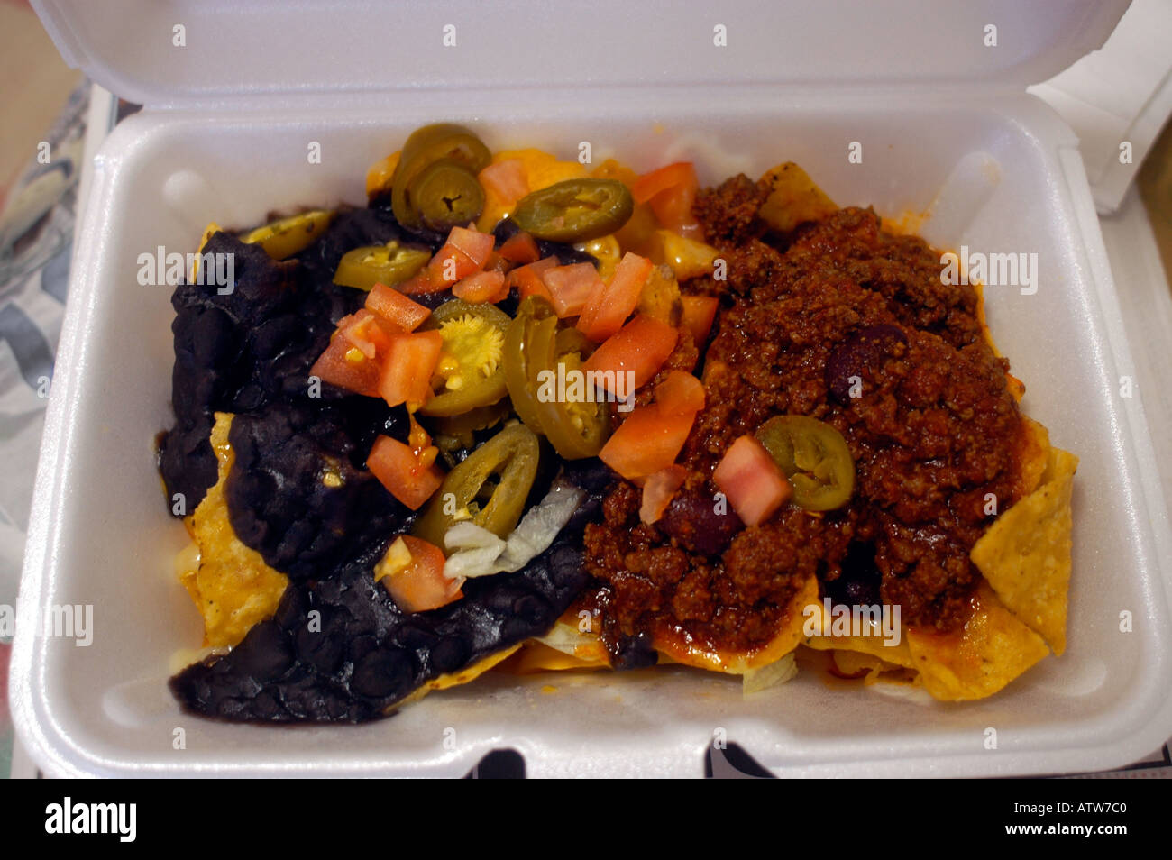 Tex Mex nachos in a stryofoam tray Stock Photo