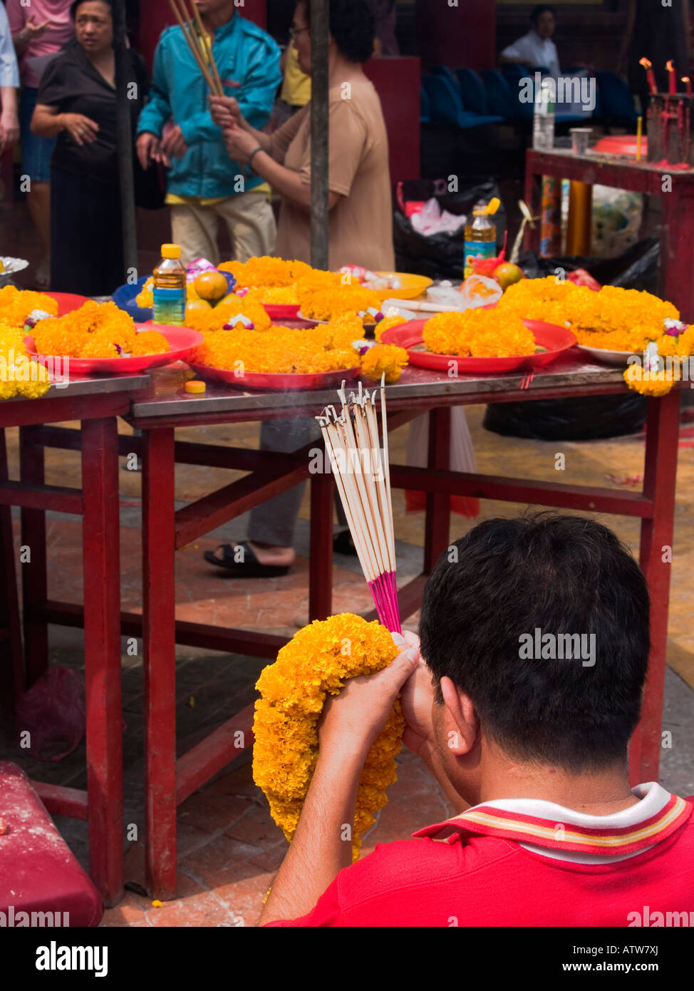 prayers for good luck at a shrine during Chinese New Year in Bangkok