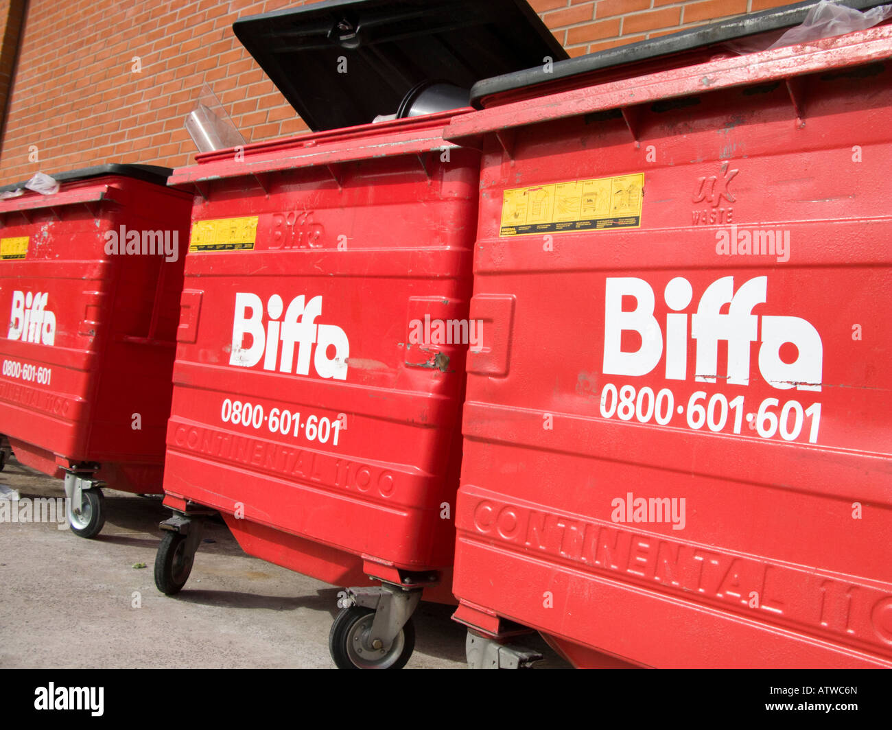 three 3 Biffa red wheelie bins Stock Photo
