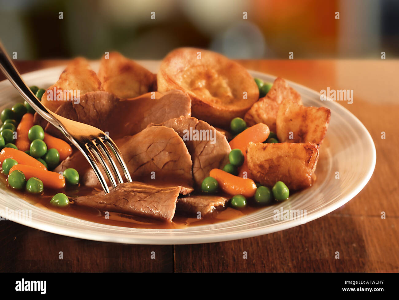 Traditional roast beef dinner with roast potatoes and yorkshire pudding Stock Photo