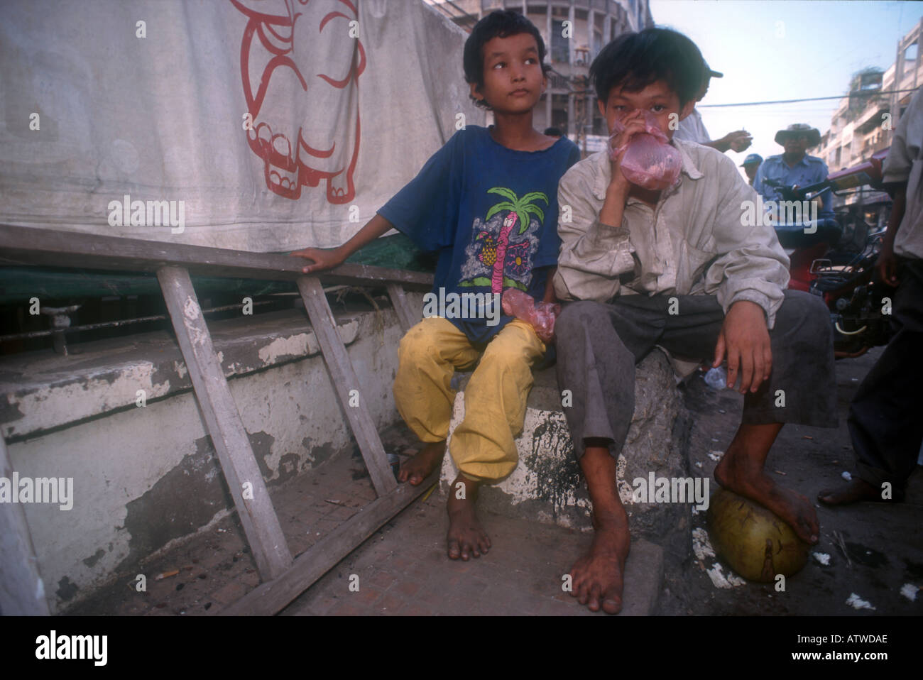 Street children sniffing glue in Phnom Penh Cambodia Stock Photo
