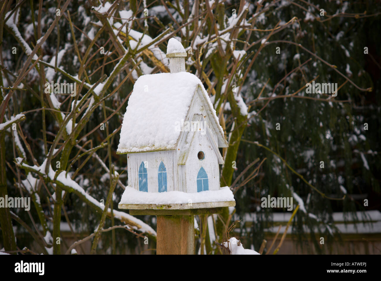 Church style bird house covered in snow Stock Photo